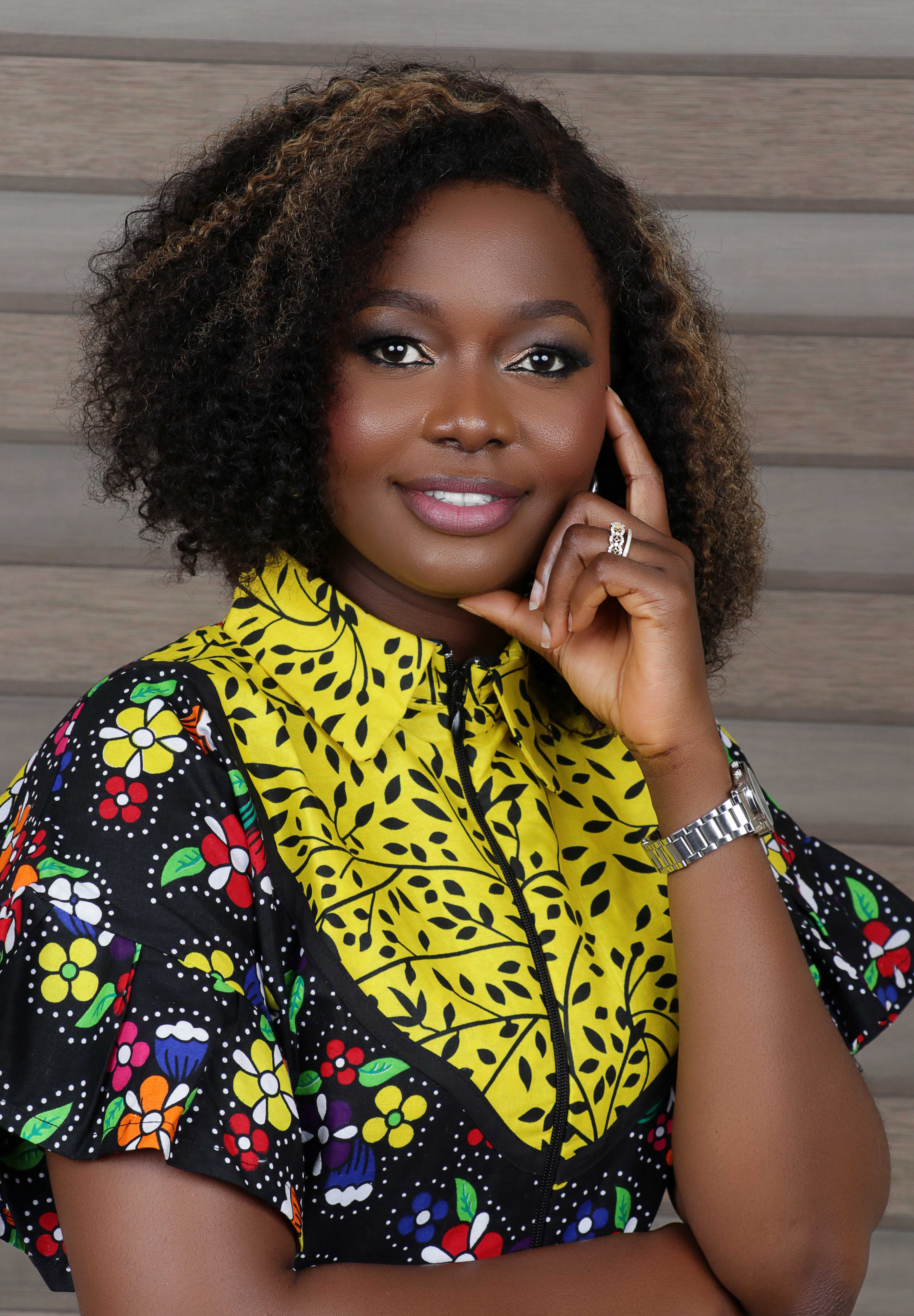 Stella Chinonso Adesina smiling in yellow and black dress