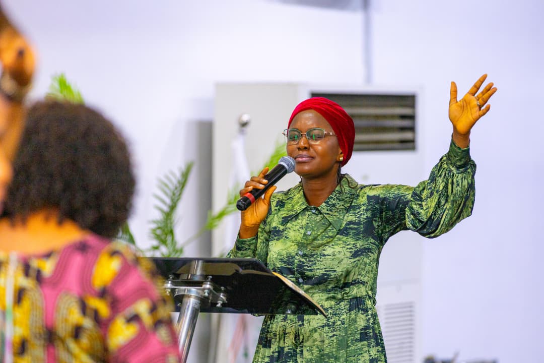 Speaker praying at Woman thou art loosed 2025 prayer meeting